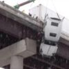Watch: Driver hoisted to safety from truck dangling over West Virginia bridge